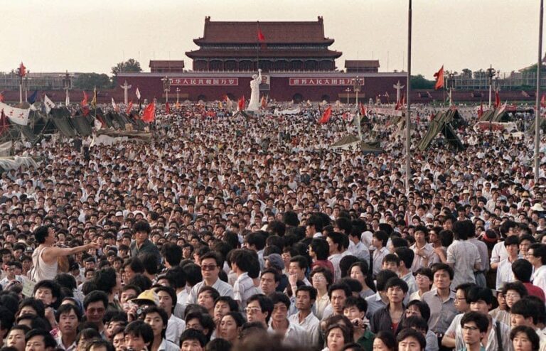 A photo of students forming a chain to block crowds from attacking soldiers|